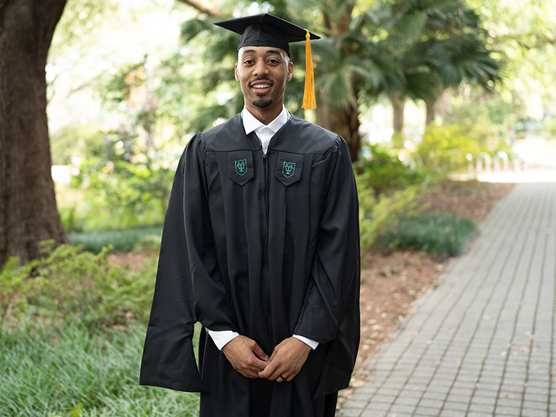 SoPA graduate with trees in the background
