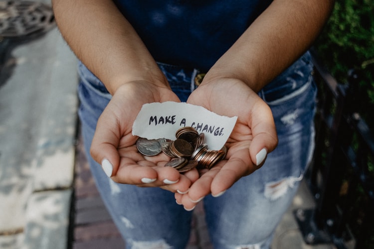 Hands holding change and a note that states 'Make a change'