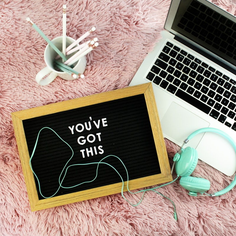 A chalkboard next to a laptop that says 'You've Got This'