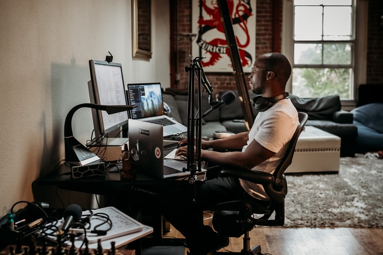 A professional working from home using tech equipment