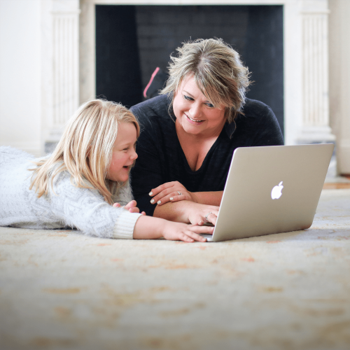 Woman and girl on laptop, engaged in learning for Tulane School of Professional Advancement in New Orleans.