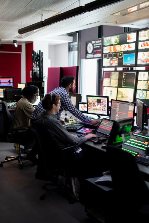 Humanities graduates working at a work station with many screens - Tulane School of Professional Advancement