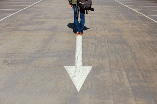 Person standing in front of an arrow representing Tulane School of Professional Advancement's continuing studies programs in New Orleans, LA