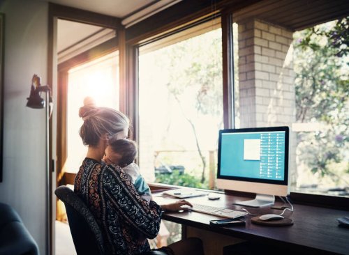 Learn more about our degree programs A woman holding a baby representing a parent's guide to going back to school by Tulane School of Professional Advancement in New Orleans, LA