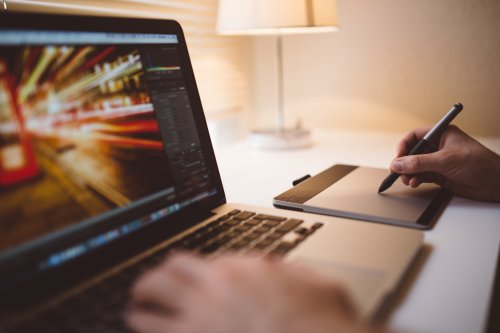 Learn about motion design A designer using a drawing tablet with their laptop