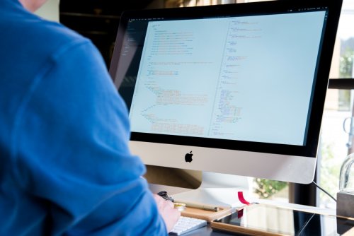 Learn about cybersecurity A person writing code on their desktop computer