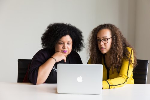 Two women looking at a laptop screen - Tulane School of Professional Advancement