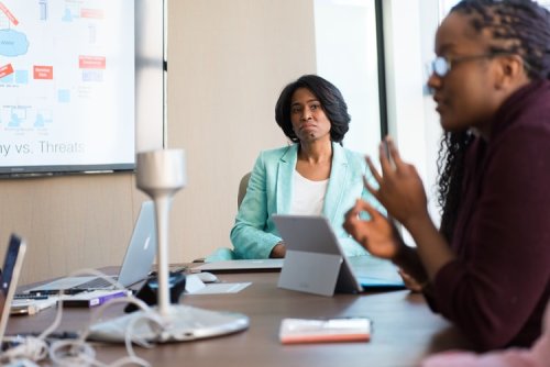 IT Professionals talking around a table - Tulane School of Professional Advancement