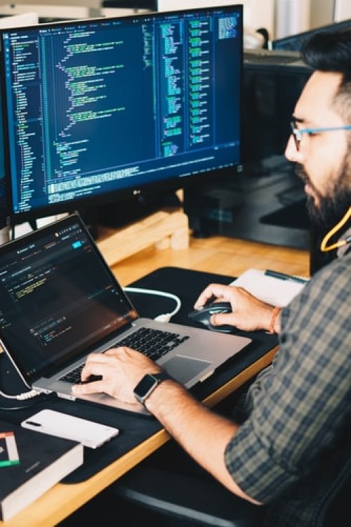 Man coding on laptop - Tulane School of Professional Advancement