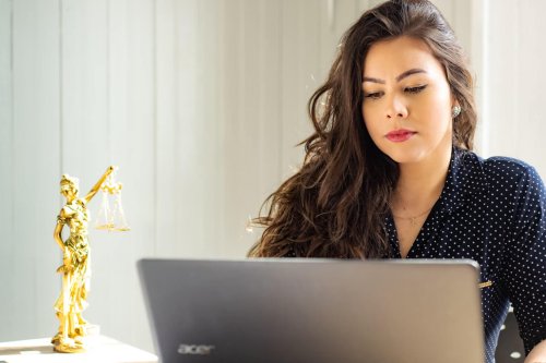 Legal student working at a computer - Tulane School of Professional Advancement