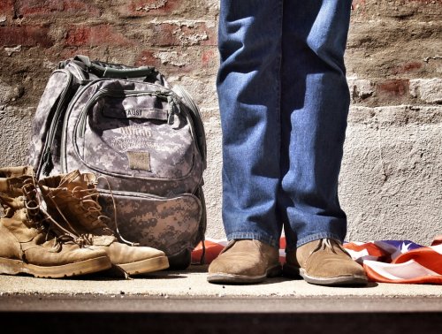 A person standing next to military gear