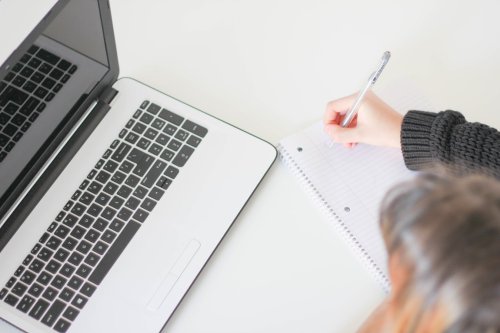 Learn how proficient writing skills are important for your career A student taking notes next to a laptop