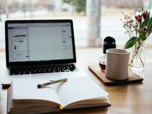 Write a stellar cover letter A notebook in front of a laptop on a desk