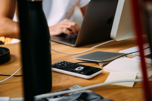Find out more about accounting degrees A calculator next to a laptop