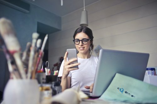 A student in an art room looking at their phone