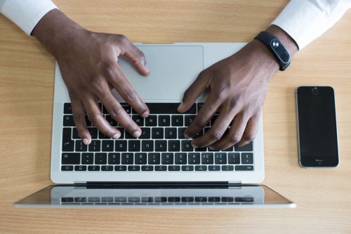 A person typing on a laptop