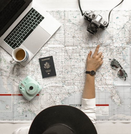 Should you take a gap year? A person looking at a map with other travel accessories