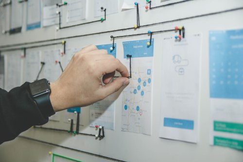 A person making a push-pin graph