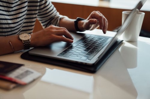 A person typing on a laptop