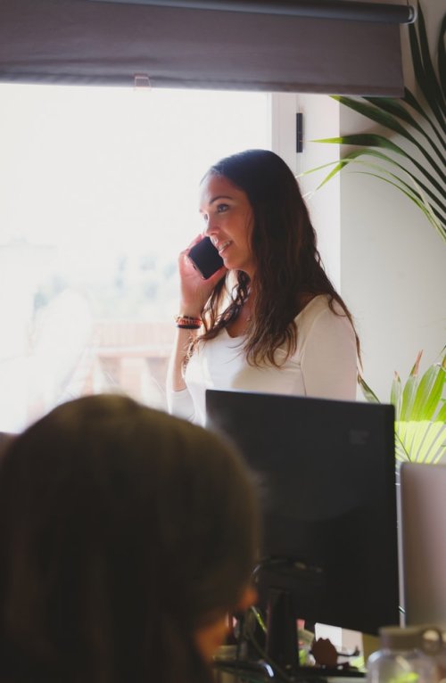 A woman talking on her phone in an office