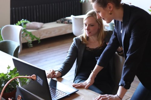 Learn why startups need HR professionals Two women professionals working on a laptop