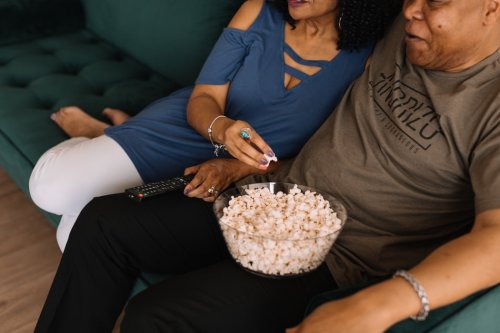 Learn about Nielsen Ratings A couple on a couch eating popcorn