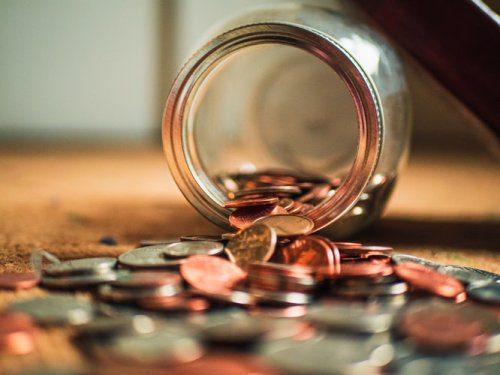 Learn more about paying for college A jar with change spilling out of it