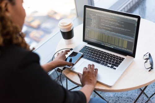 Learn about the differences between software architecture and security design A woman working on code on her laptop