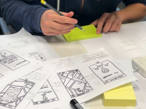 A person sketching UX mockups