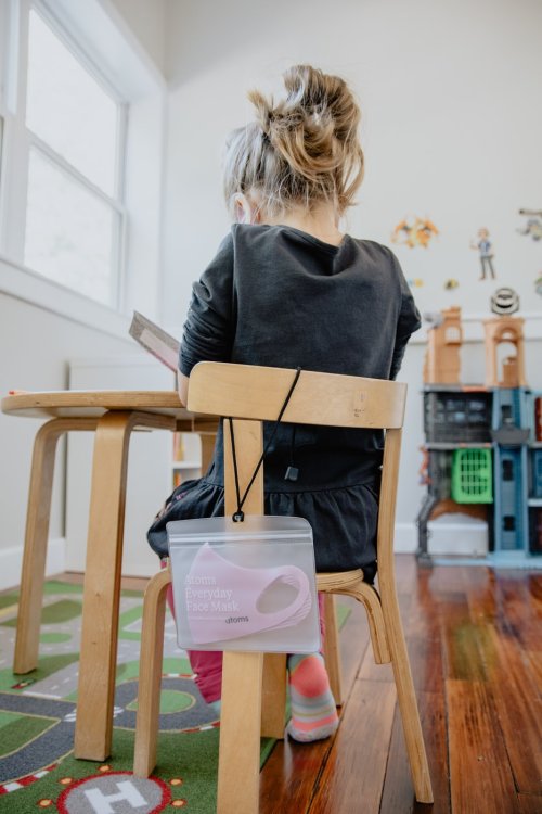 A child sitting in a chair in a classroom