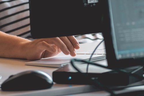 Cybersecurity professional working at a computer - Tulane School of Professional Advancement