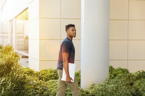 Transfer student walking on university campus - Tulane School of Professional Advancement