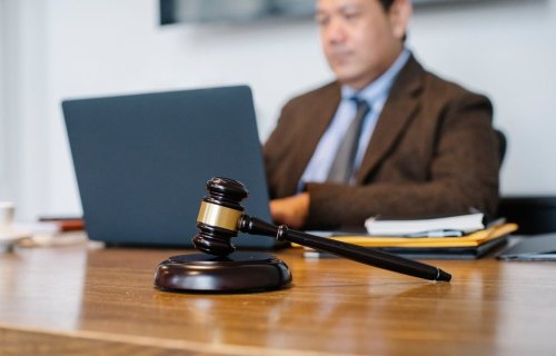 A gavel sitting on a desk of a person working