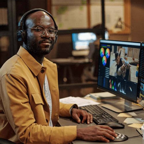 man with headphones at a computer