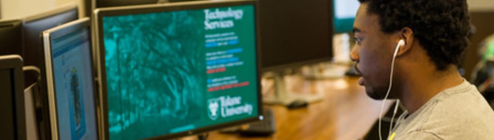A student working on a computer representing Tulane School of Professional Advancement's information technology degree program in New Orleans, LA