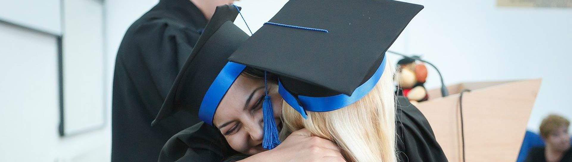 College graduates hugging on graduation day