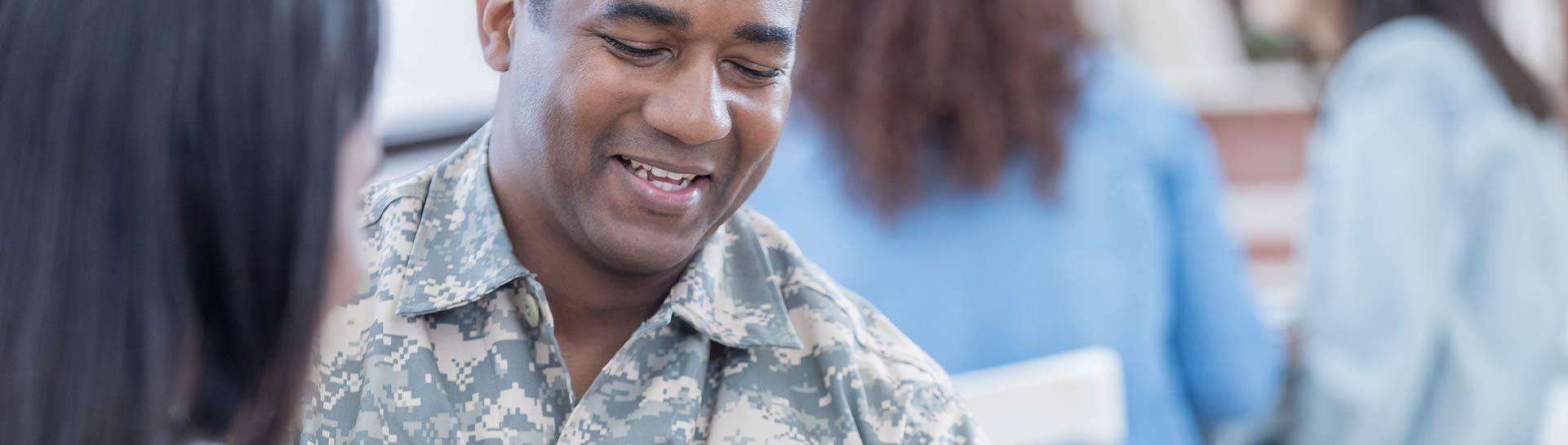 A smiling member of the military