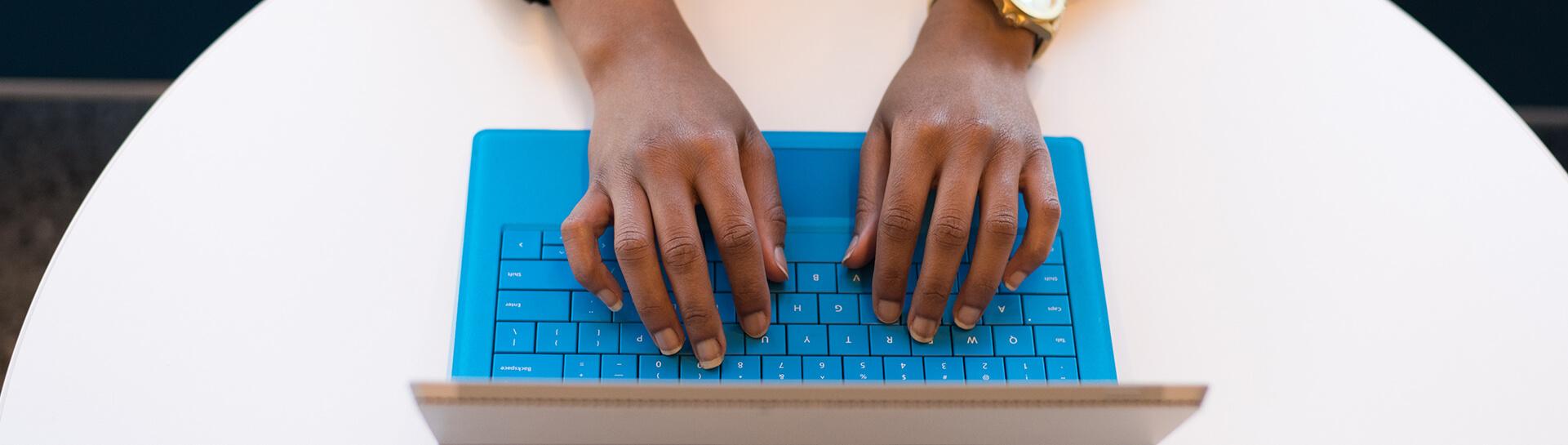 A student typing on a laptop