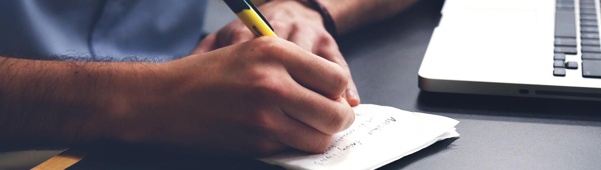 A person taking handwritten notes