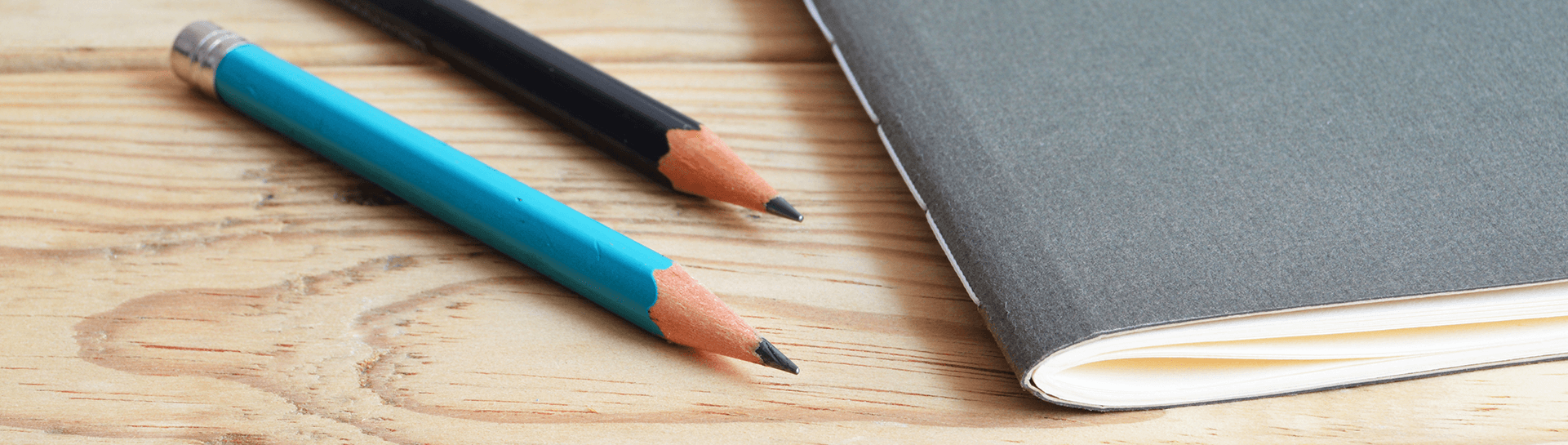 Pencils next to a notebook