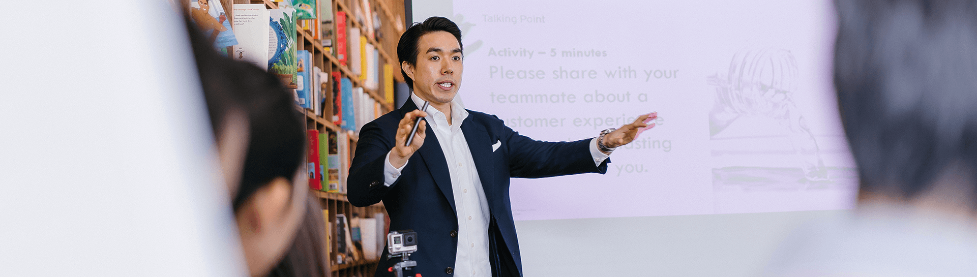 A man in a suit giving a lecture