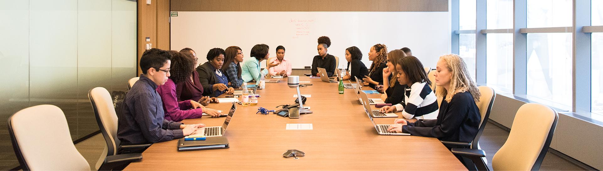 A group of professionals sitting at a conference room table