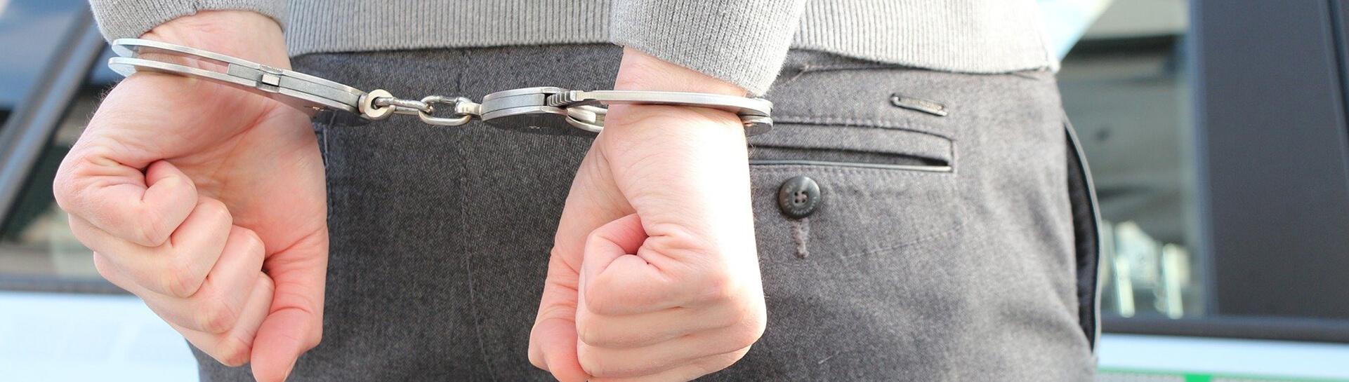 A person's hands in handcuffs