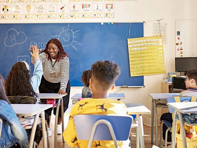 Tulane SoPA Master of Teaching degree graduate with her students in the classroom