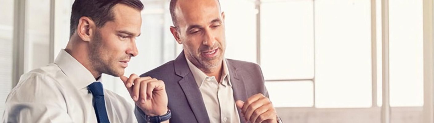 Two men representing the Tulane School of Professional Advancement in New Orleans, LA's ways to become a chief information officer