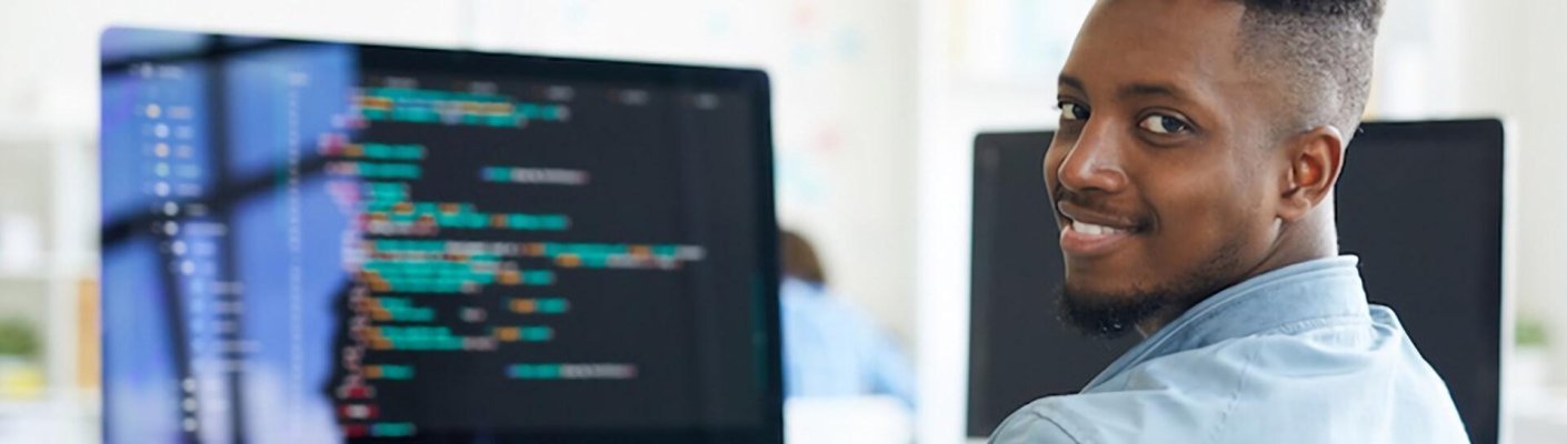 A man on a computer representing steps to being an IT Manager with Tulane School of Professional Advancement's info tech degree program in New Orleans, LA