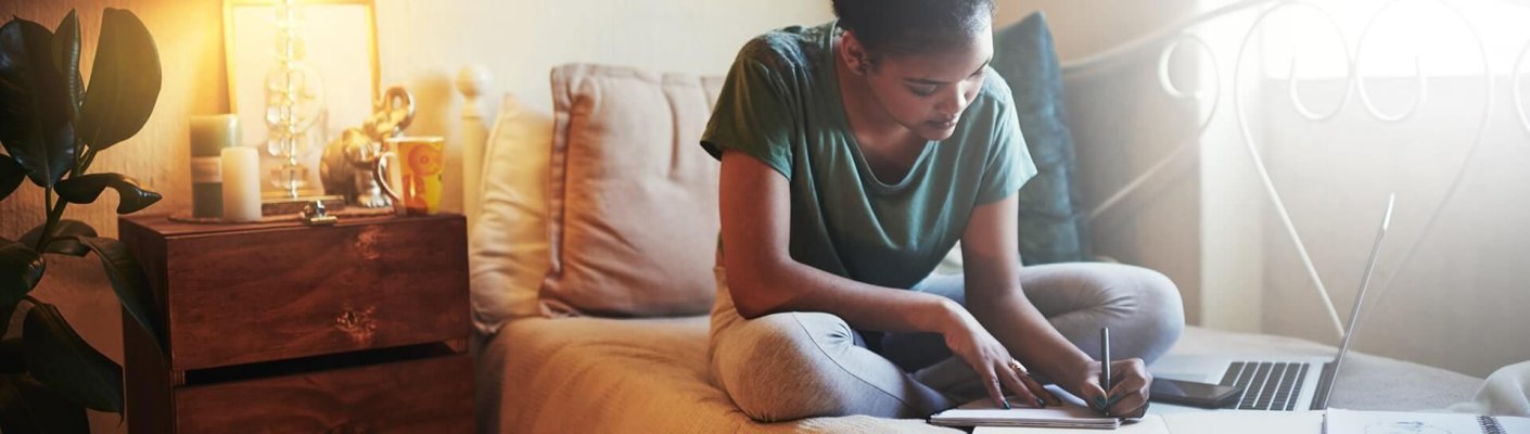 A student studying online in their room