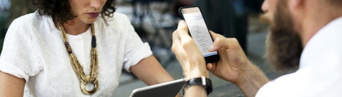 People on electronics at a networking event