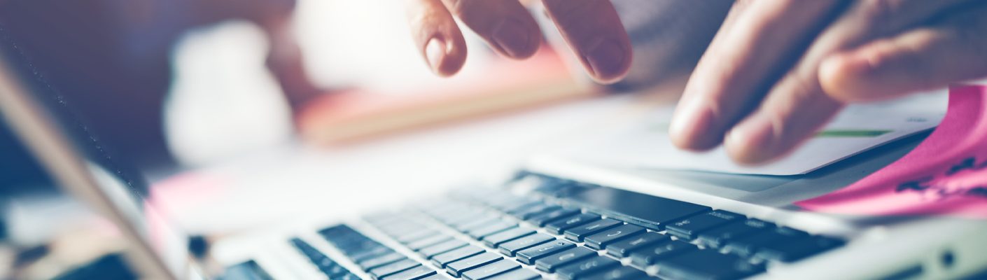 A person typing on a laptop