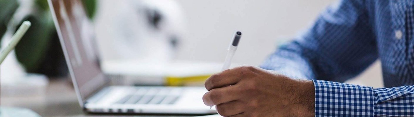 A hand holding a pen